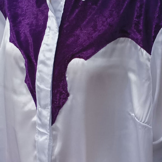 This video shows how the light shimmers off of the white satin and purple crushed velvet fabric on this handmade western shirt. The yoke is made in the old school western shirt style with the curves and points meeting up in the middle alongside the button placket. C Boondocks Treasures Boutique 2025