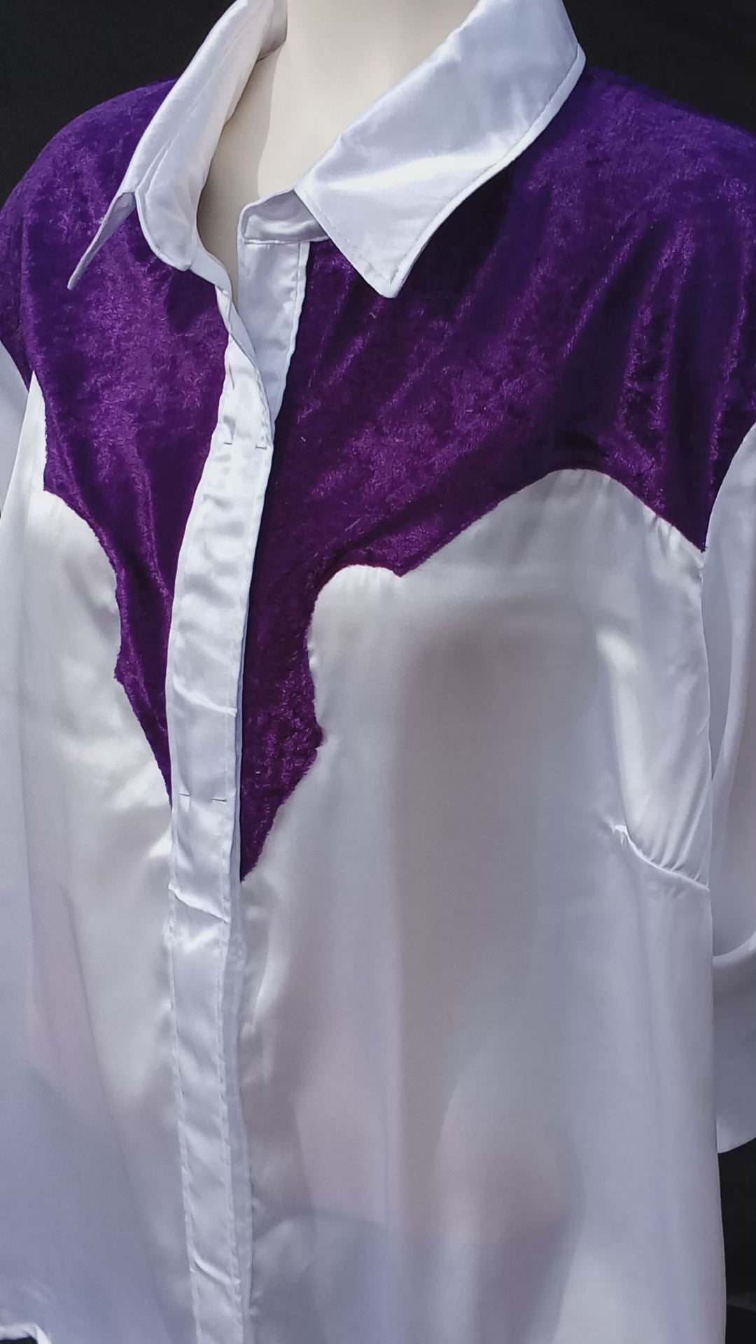 This video shows how the light shimmers off of the white satin and purple crushed velvet fabric on this handmade western shirt. The yoke is made in the old school western shirt style with the curves and points meeting up in the middle alongside the button placket. C Boondocks Treasures Boutique 2025