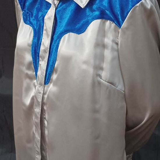 This video shows how the light shimmers off of the silver-gray satin and royal blue crushed velvet on this handmade shirt. It features an old school western yoke which is created using the crushed velvet fabric. C Boondocks Treasures Boutique 2025