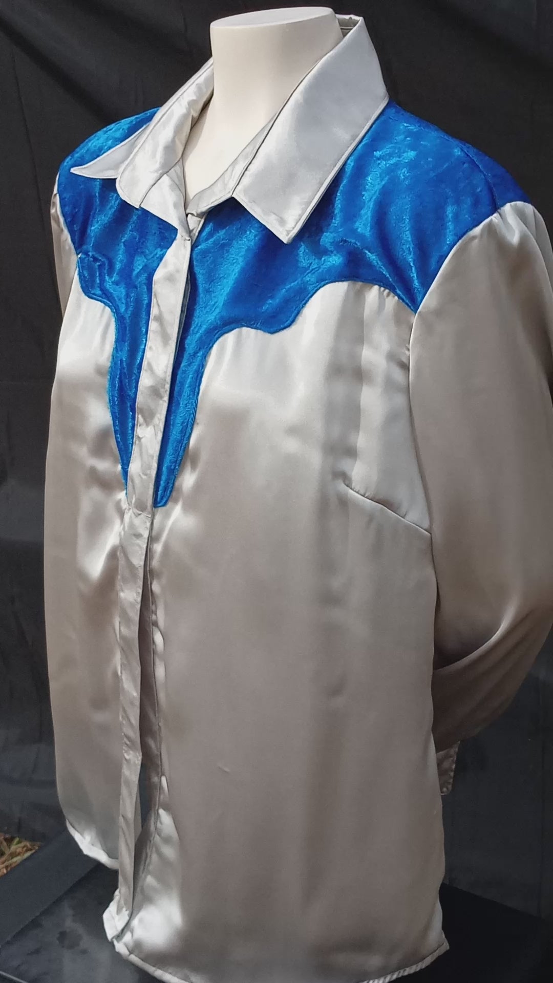 This video shows how the light shimmers off of the silver-gray satin and royal blue crushed velvet on this handmade shirt. It features an old school western yoke which is created using the crushed velvet fabric. C Boondocks Treasures Boutique 2025