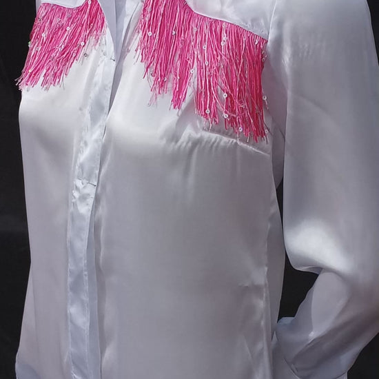 This video shows a 360 view of my handmade white with pink sparkly fringe western shirt. It highlights the way the light reflects off of satin fabric as well as the pink sparkly fringe accent. My customers have the option of buttons or pearl snaps. My shirts are available in sizes XS-5XL.  C Boondocks Treasures Boutique 2025